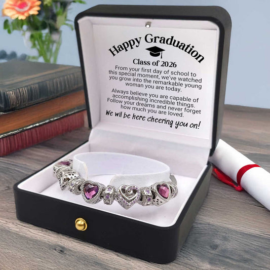 Bracelet with heart-shaped charms in a gift box with a message for 'Happy Graduation 2026'.